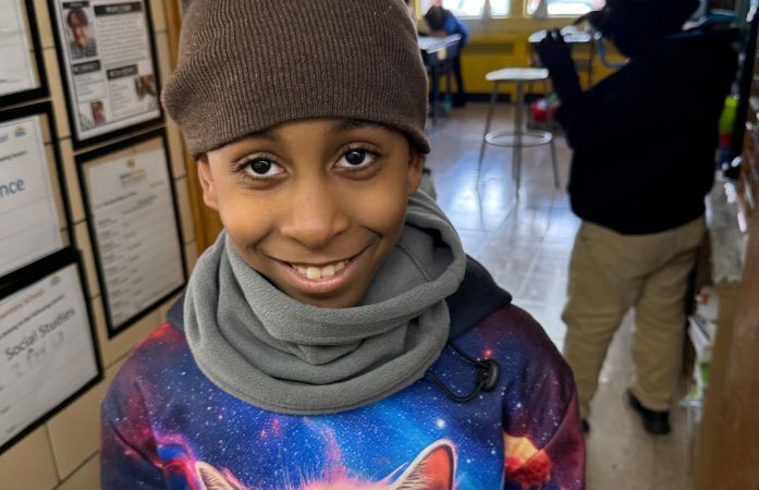  A very happy 4th grader showing off his new hat and neck warmer from his teacher.